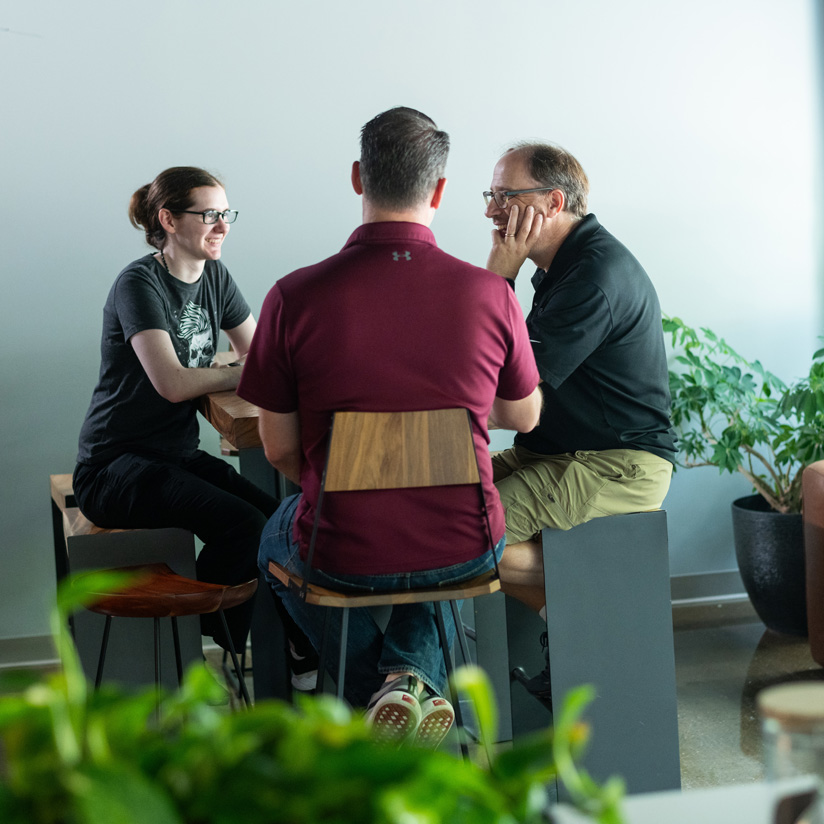 nuharbor-employees-at-a-table-824x824
