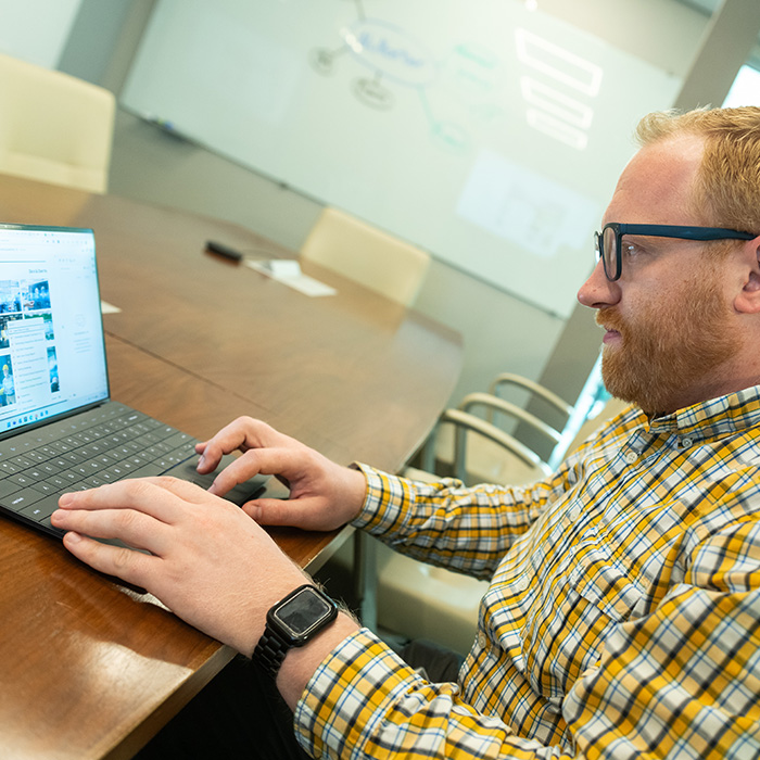 a team member working on a laptop